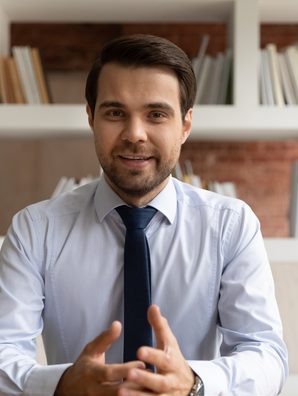 Creator in shirt and tie speaking, captioned short