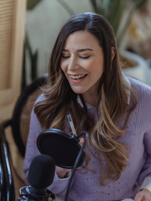 Creator speaking into a microphone, captioned short
